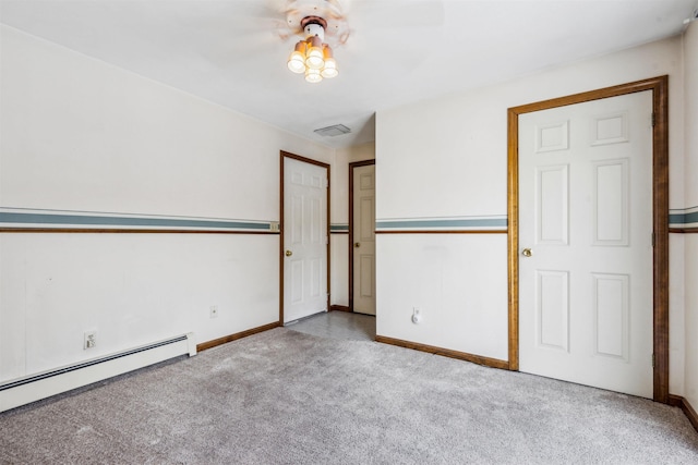 unfurnished room featuring a baseboard heating unit