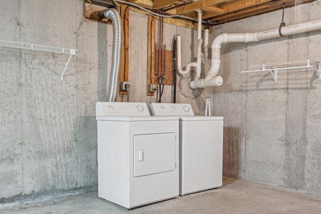 clothes washing area with washing machine and dryer