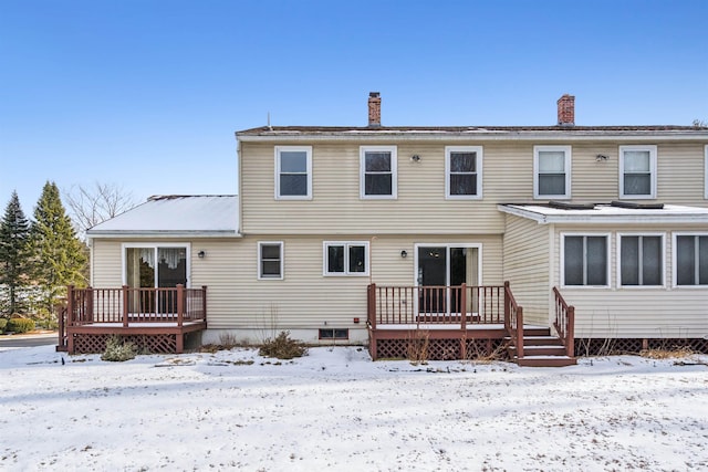 snow covered house featuring a deck