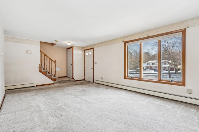 spare room with carpet and a baseboard radiator