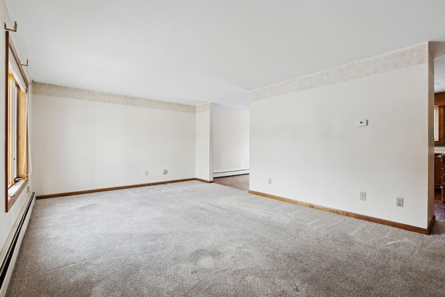 unfurnished room with carpet and a baseboard heating unit