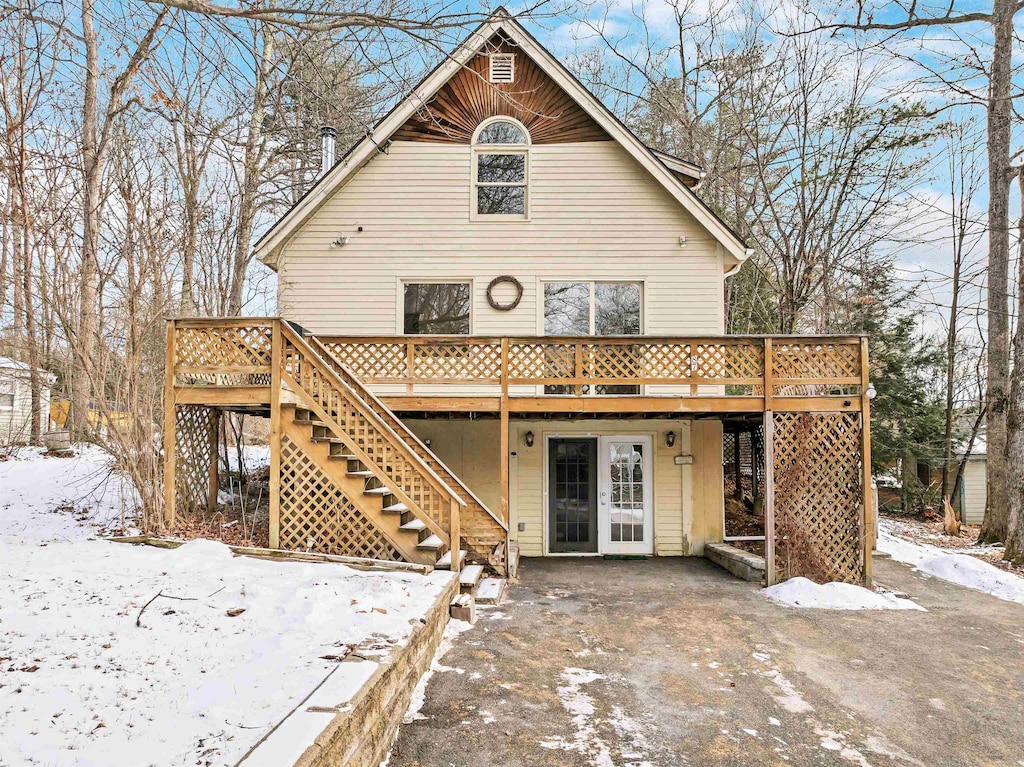 snow covered property with a deck