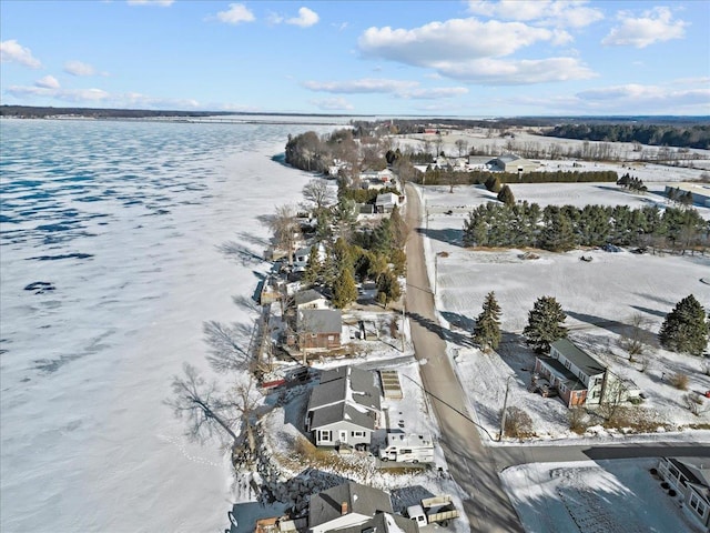 snowy aerial view with a water view