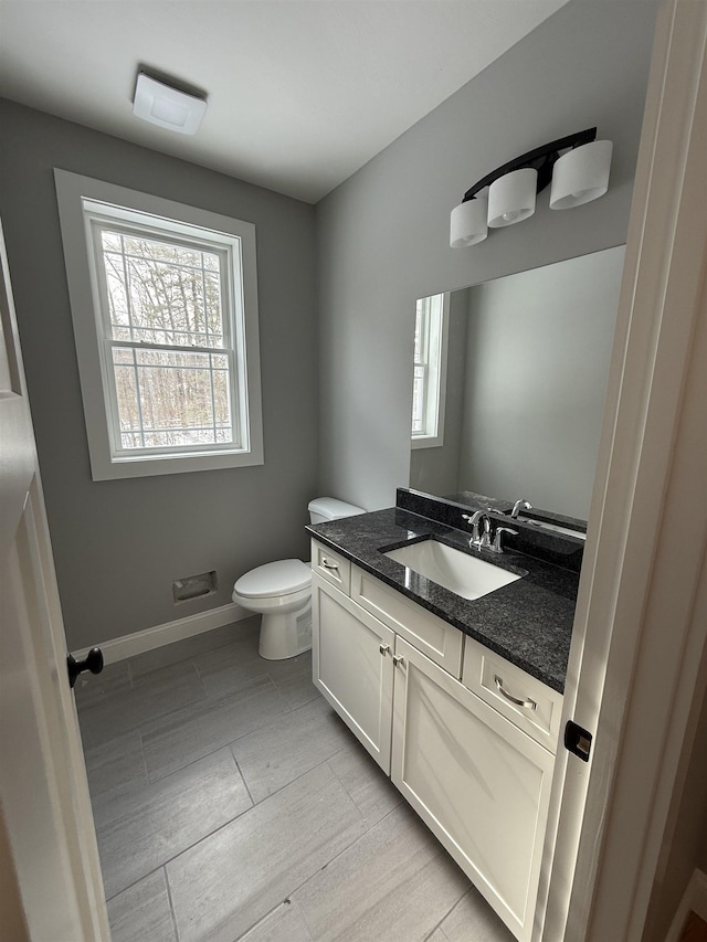 bathroom featuring vanity, tile patterned flooring, and toilet