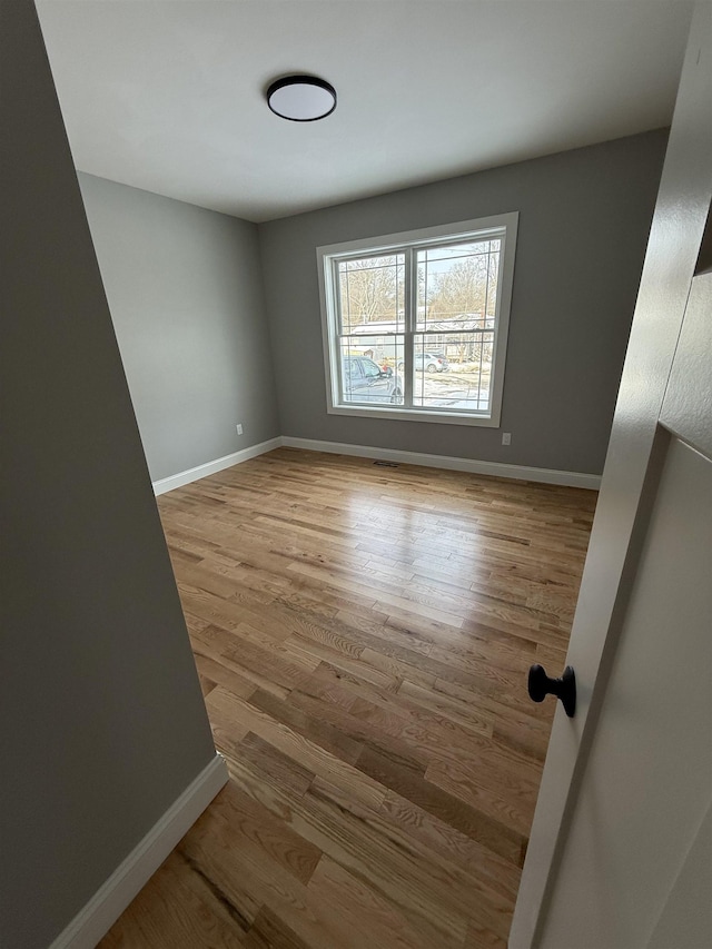 spare room with light hardwood / wood-style flooring