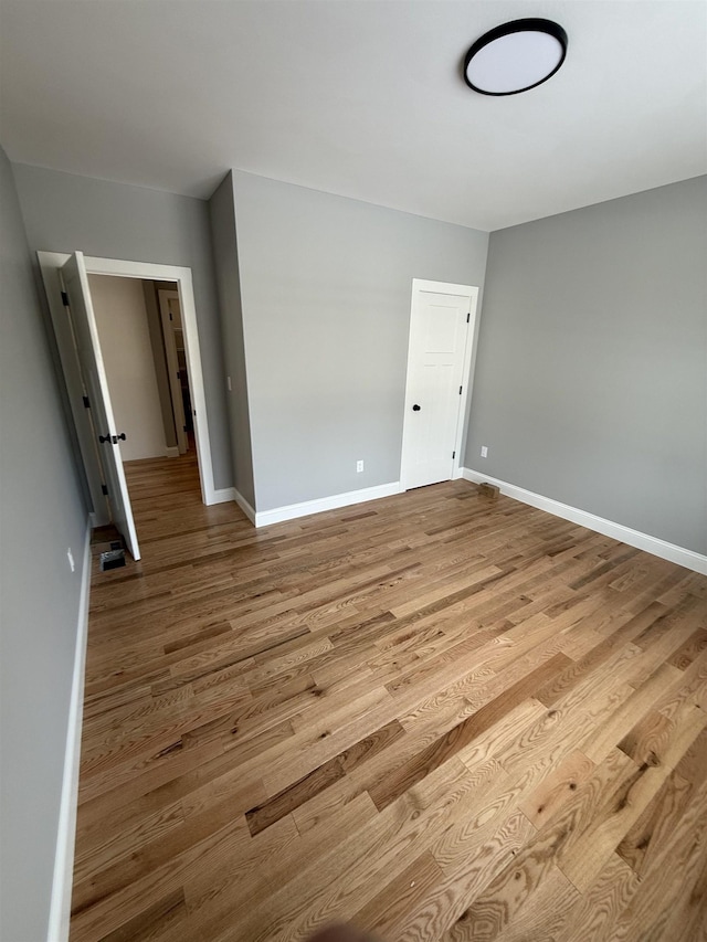 spare room with light hardwood / wood-style floors