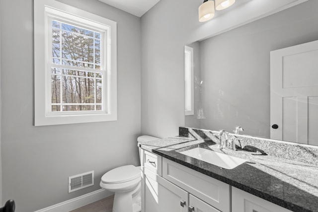 bathroom featuring vanity and toilet