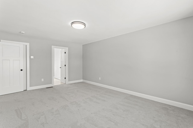 unfurnished room with light colored carpet