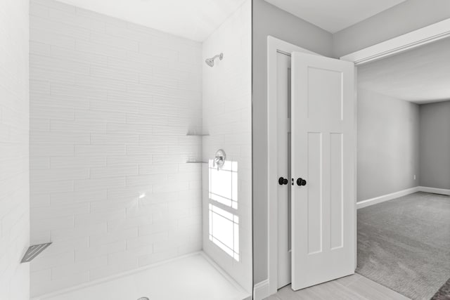 bathroom with a tile shower