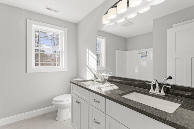 bathroom with vanity, toilet, and walk in shower