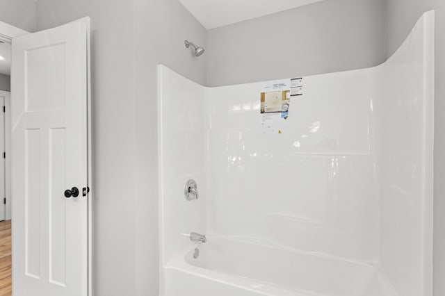 bathroom featuring hardwood / wood-style flooring and shower / bathtub combination