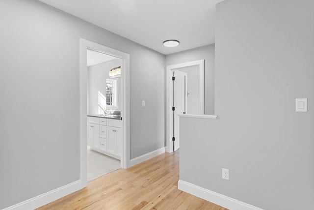 corridor with light hardwood / wood-style floors