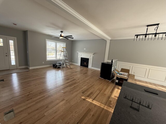 unfurnished living room featuring ceiling fan and hardwood / wood-style floors