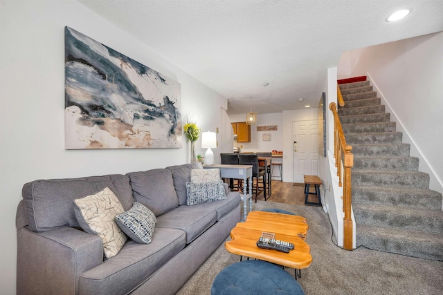 carpeted living room featuring a textured ceiling