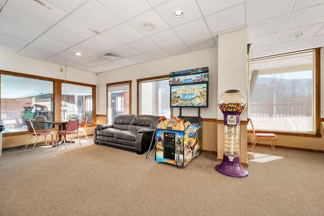 living room featuring carpet floors and a paneled ceiling