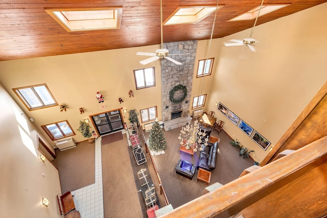 living room with a fireplace, high vaulted ceiling, ceiling fan, and wood ceiling