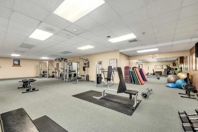 workout area with a paneled ceiling