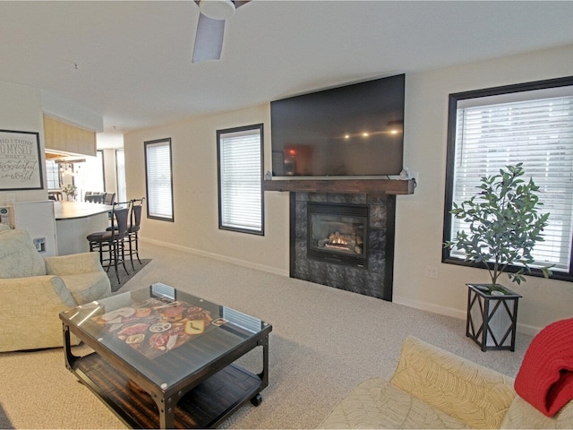 carpeted living room with ceiling fan