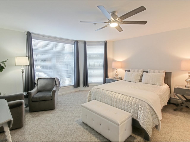 bedroom with light colored carpet and ceiling fan