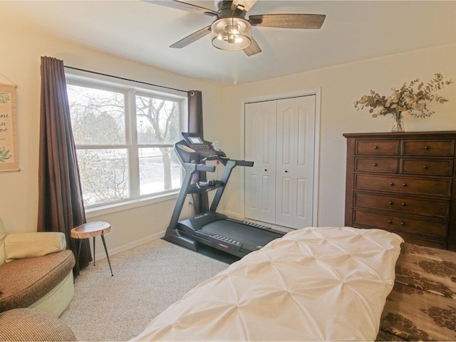 workout area featuring ceiling fan and light colored carpet