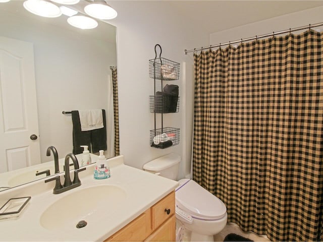 bathroom with toilet and vanity