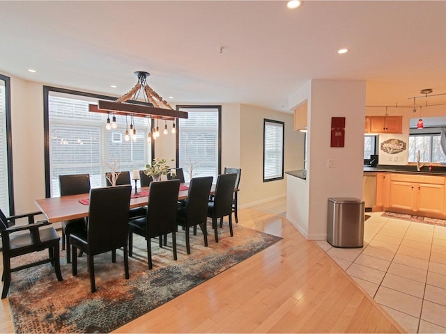 dining space featuring sink and light wood-type flooring