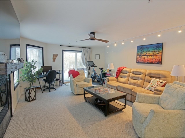 carpeted living room with ceiling fan