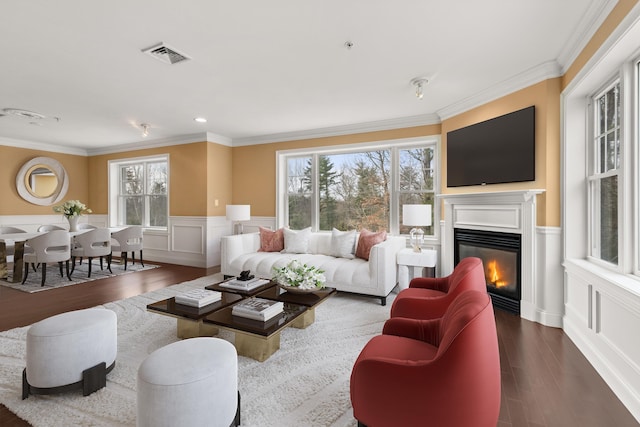 living room with dark wood-type flooring and ornamental molding