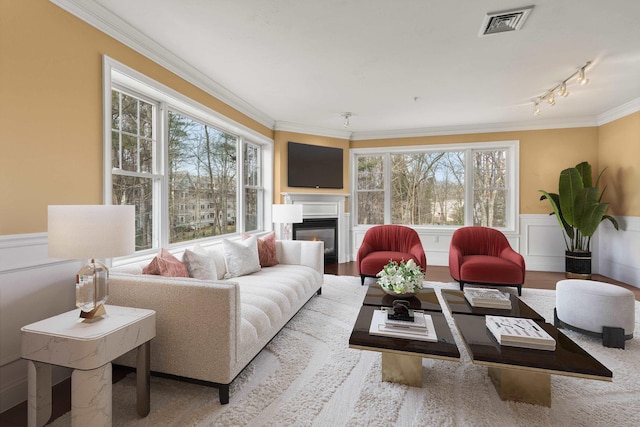 living room featuring light wood-type flooring and crown molding