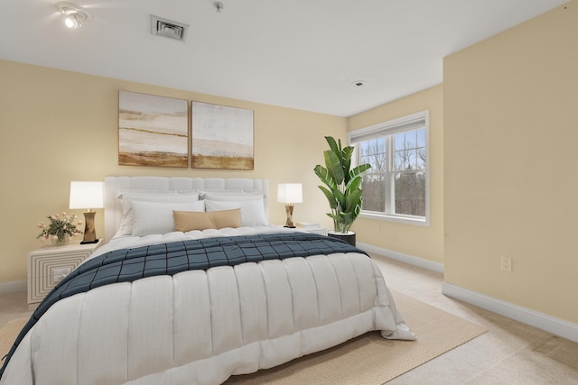 bedroom featuring light colored carpet