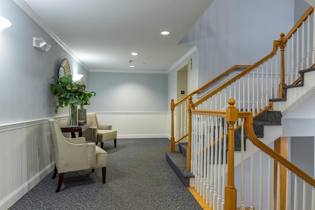 living area with crown molding and dark carpet