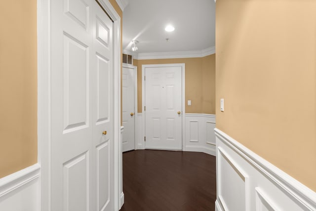 hallway with dark hardwood / wood-style floors and ornamental molding