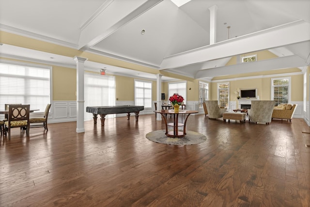 playroom with ornamental molding, ornate columns, plenty of natural light, and dark wood-type flooring