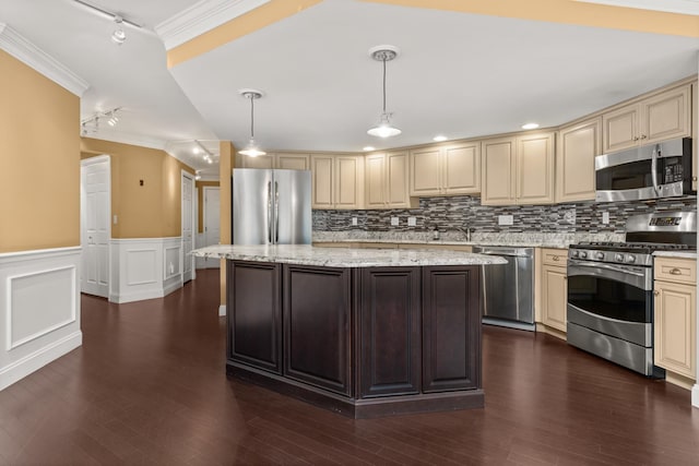 kitchen with crown molding, light stone countertops, appliances with stainless steel finishes, hanging light fixtures, and track lighting