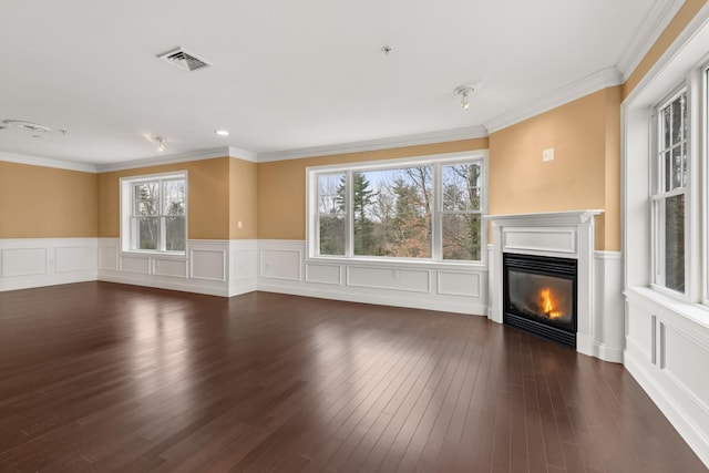 unfurnished living room featuring dark wood-type flooring and ornamental molding