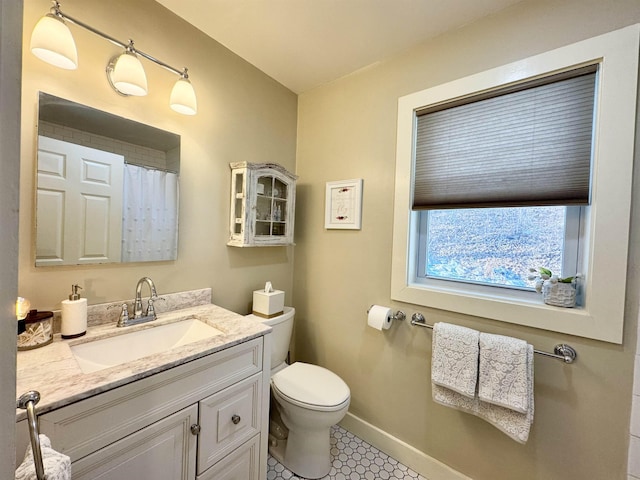 bathroom featuring vanity, toilet, walk in shower, and tile patterned flooring