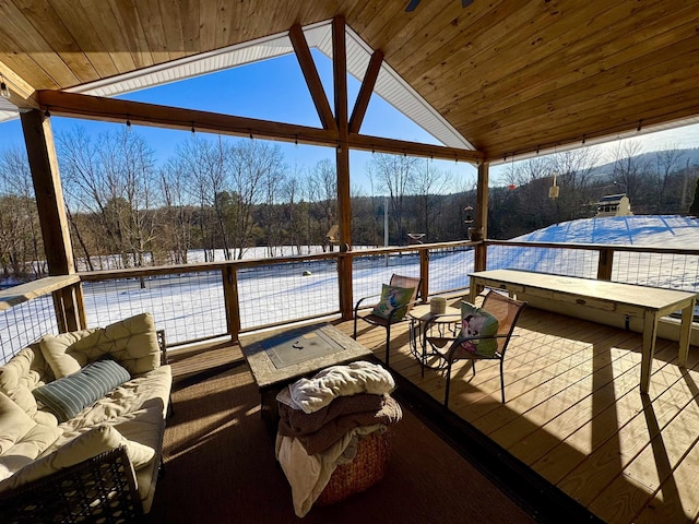 snow covered deck featuring an outdoor living space