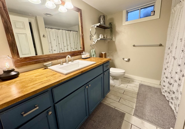 bathroom featuring toilet and vanity