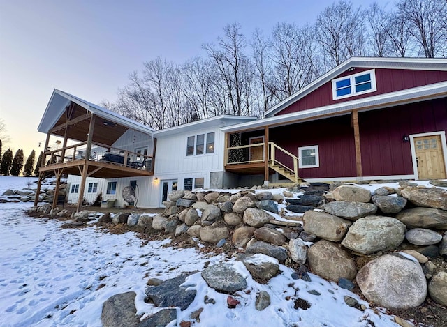 view of snowy exterior with a deck