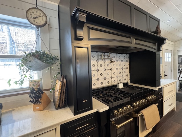 kitchen with range with two ovens and dark hardwood / wood-style flooring