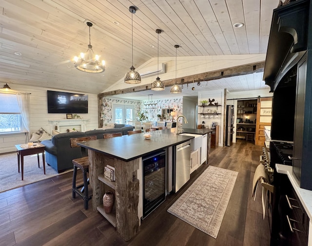 kitchen with beverage cooler, dark wood-type flooring, hanging light fixtures, wooden ceiling, and a center island with sink