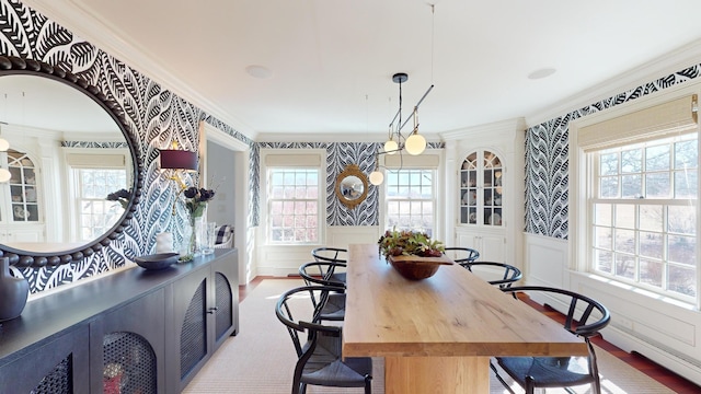 dining area featuring crown molding and light wood-type flooring