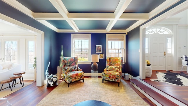 living area featuring coffered ceiling, beam ceiling, and ornamental molding