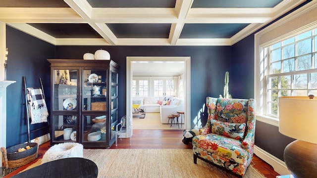 sitting room with beamed ceiling, ornamental molding, coffered ceiling, and dark hardwood / wood-style flooring