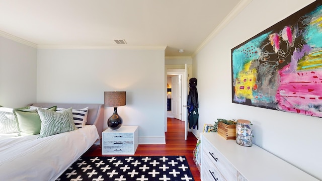 bedroom with ornamental molding and dark hardwood / wood-style floors