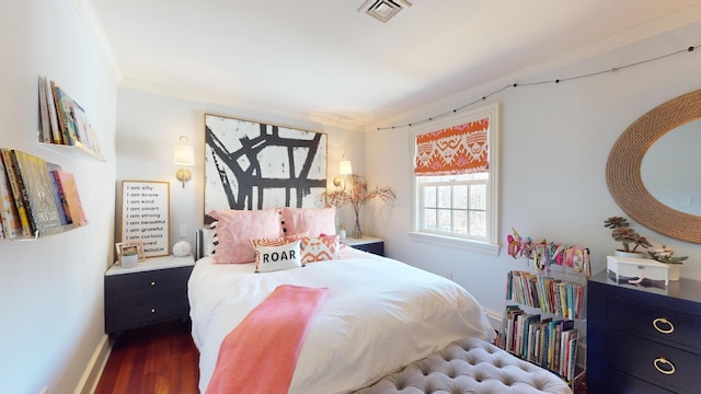 bedroom with dark hardwood / wood-style flooring and crown molding