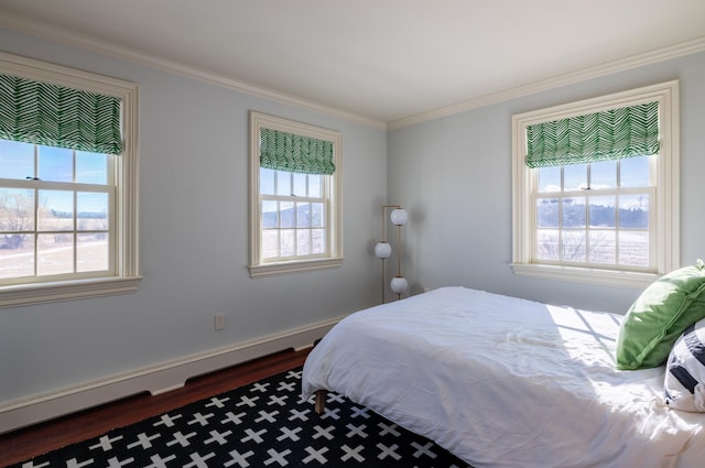 bedroom with hardwood / wood-style flooring, ornamental molding, and baseboard heating