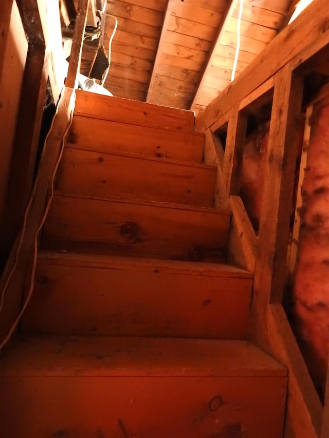 staircase with beam ceiling and wooden ceiling