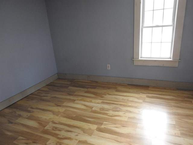 spare room with light wood-type flooring