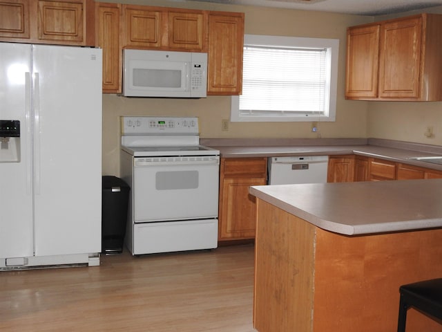 kitchen featuring white appliances and light wood-type flooring